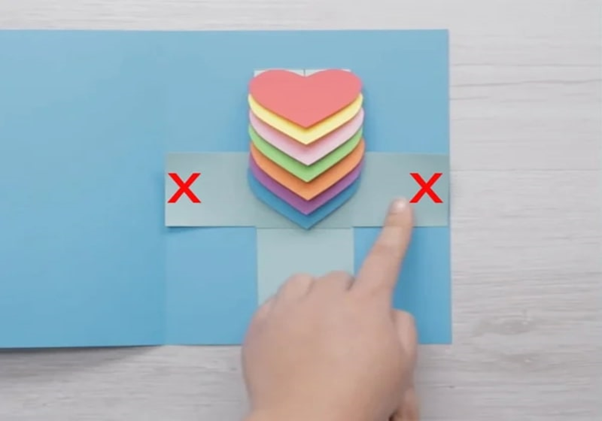 Stick a strip of paper with a heart on the inside of the card